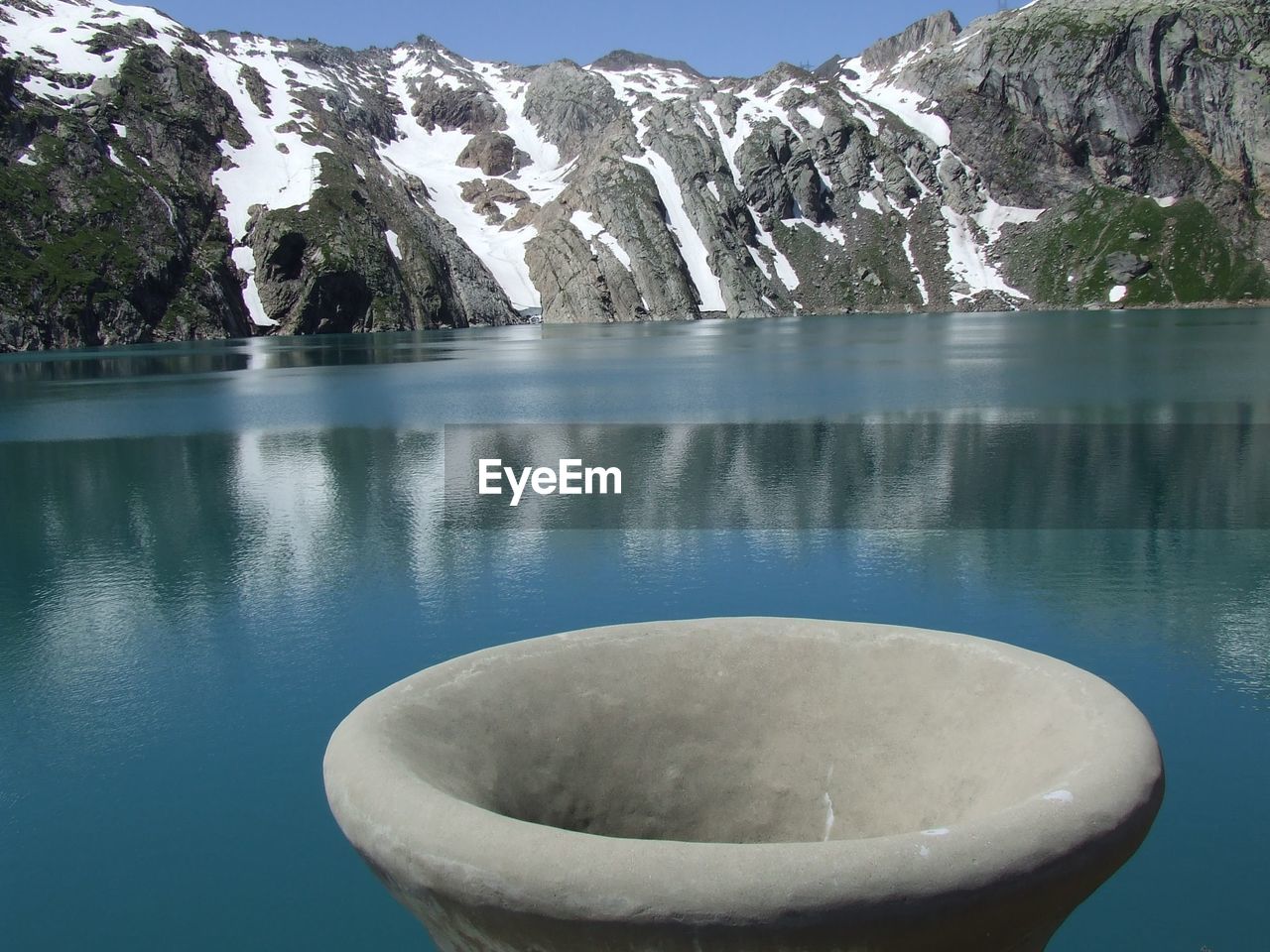 CLOSE-UP OF SWIMMING POOL BY LAKE