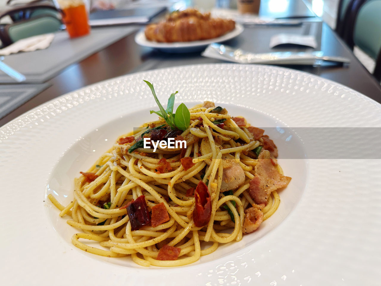 food, food and drink, italian food, pasta, plate, freshness, spaghetti, dish, table, cuisine, indoors, meal, restaurant, business, healthy eating, no people, wellbeing, serving size, close-up, herb, focus on foreground, pasta pomodoro, fork, savory food, produce, carbonara, garnish, crockery, naporitan, kitchen utensil, gourmet, eating utensil, still life, dinner, spaghetti aglio e olio