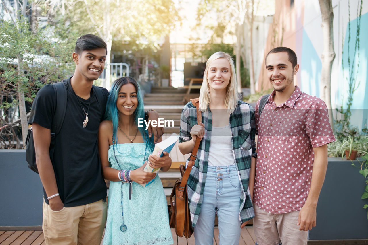 Portrait of smiling friends in campus