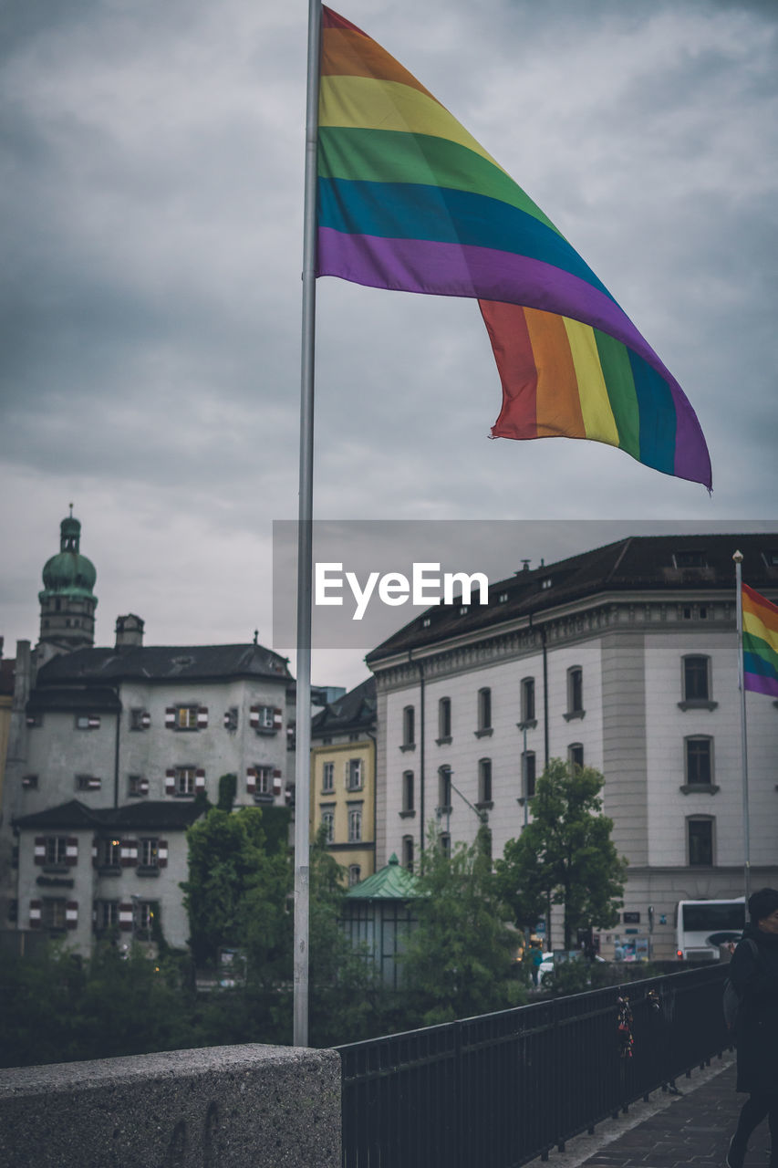 LOW ANGLE VIEW OF FLAG AGAINST BUILDINGS IN CITY