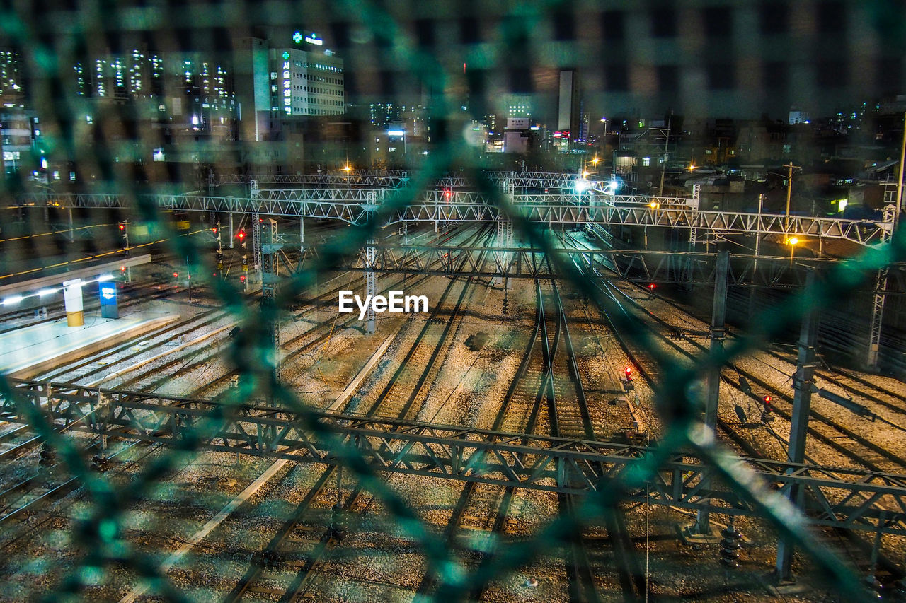 HIGH ANGLE VIEW OF ILLUMINATED LIGHTS AT NIGHT