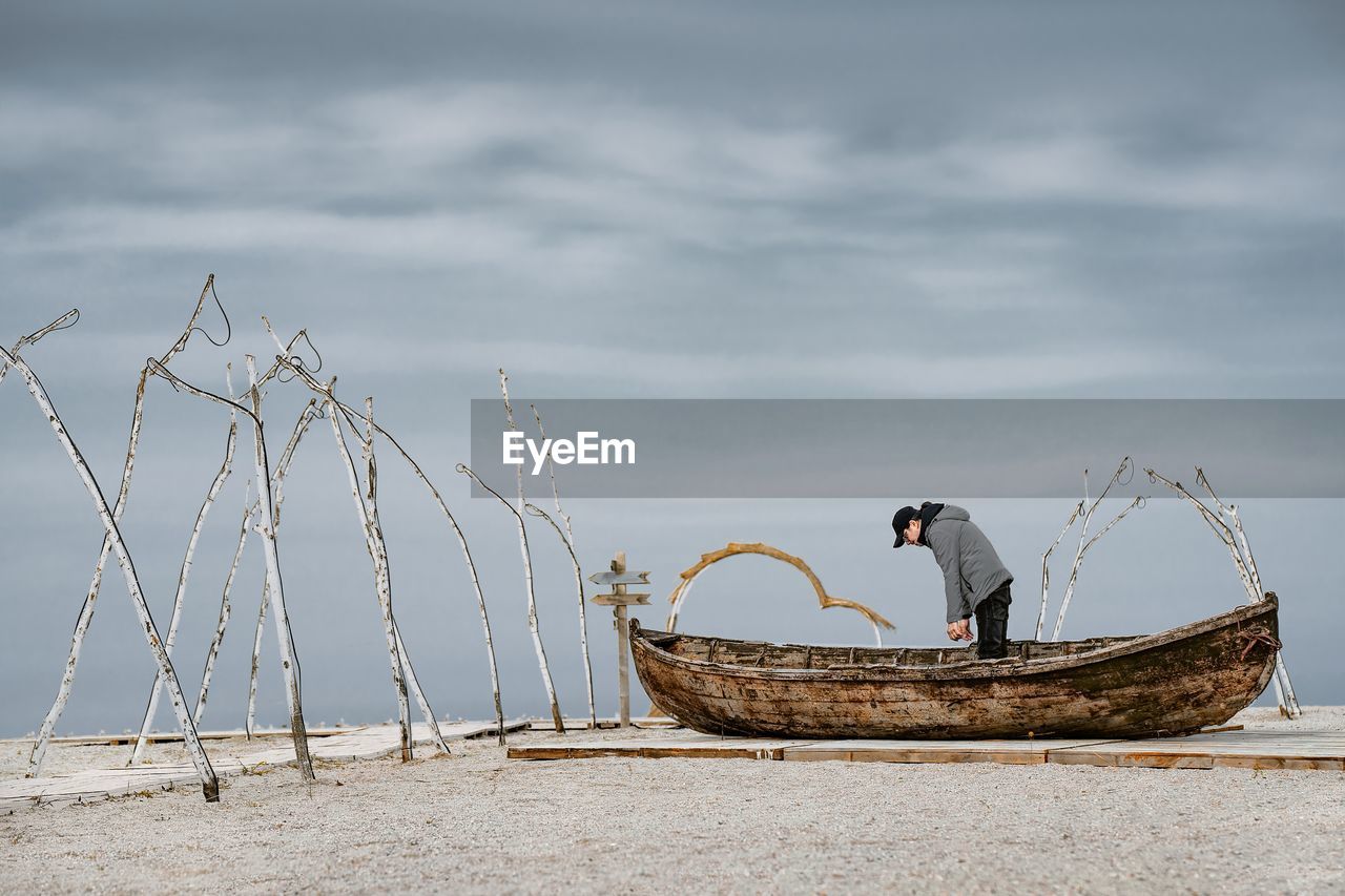 Man in boat by the sea