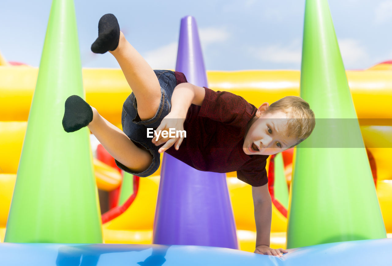 Boy jumping on bouncy castle