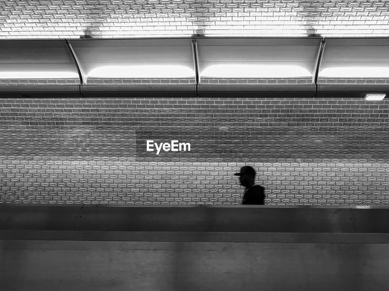 Rear view of a man walking at subway station