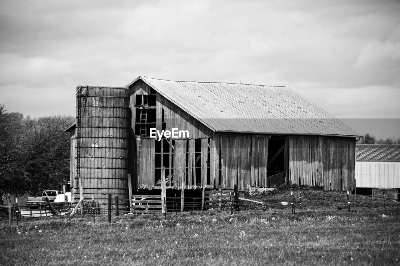 architecture, built structure, house, building exterior, sky, building, shack, black and white, barn, rural area, monochrome, cloud, nature, abandoned, monochrome photography, no people, agricultural building, landscape, rural scene, grass, plant, rundown, day, wood, farm, old, land, field, outdoors, white, home, hut, deterioration, tree, agriculture, residential district, damaged, decline, environment