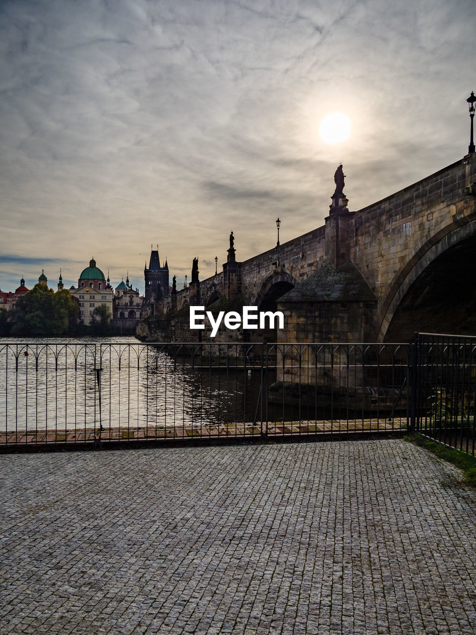 BRIDGE OVER RIVER DURING SUNSET