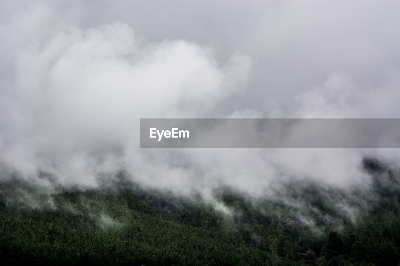 SCENIC VIEW OF CLOUDS OVER MOUNTAIN