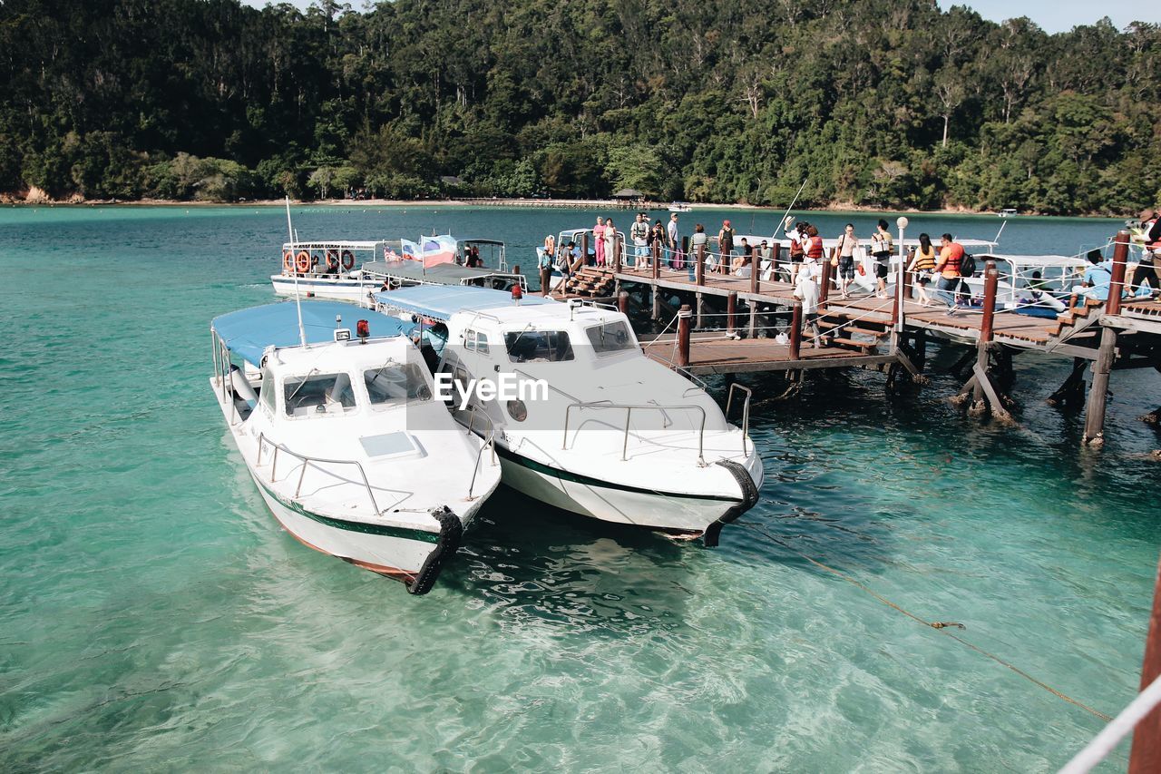 BOATS MOORED IN SEA