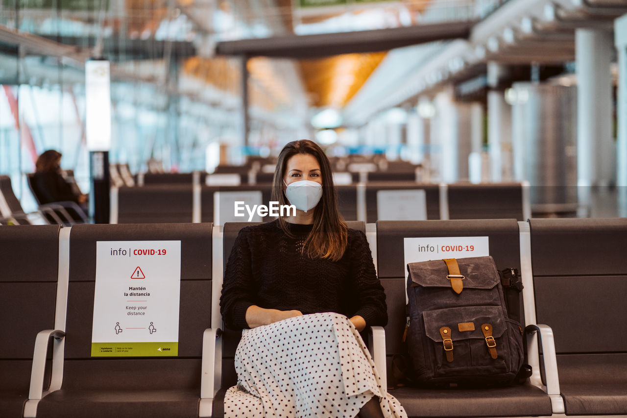 Portrait of woman sitting at airport during pandemic