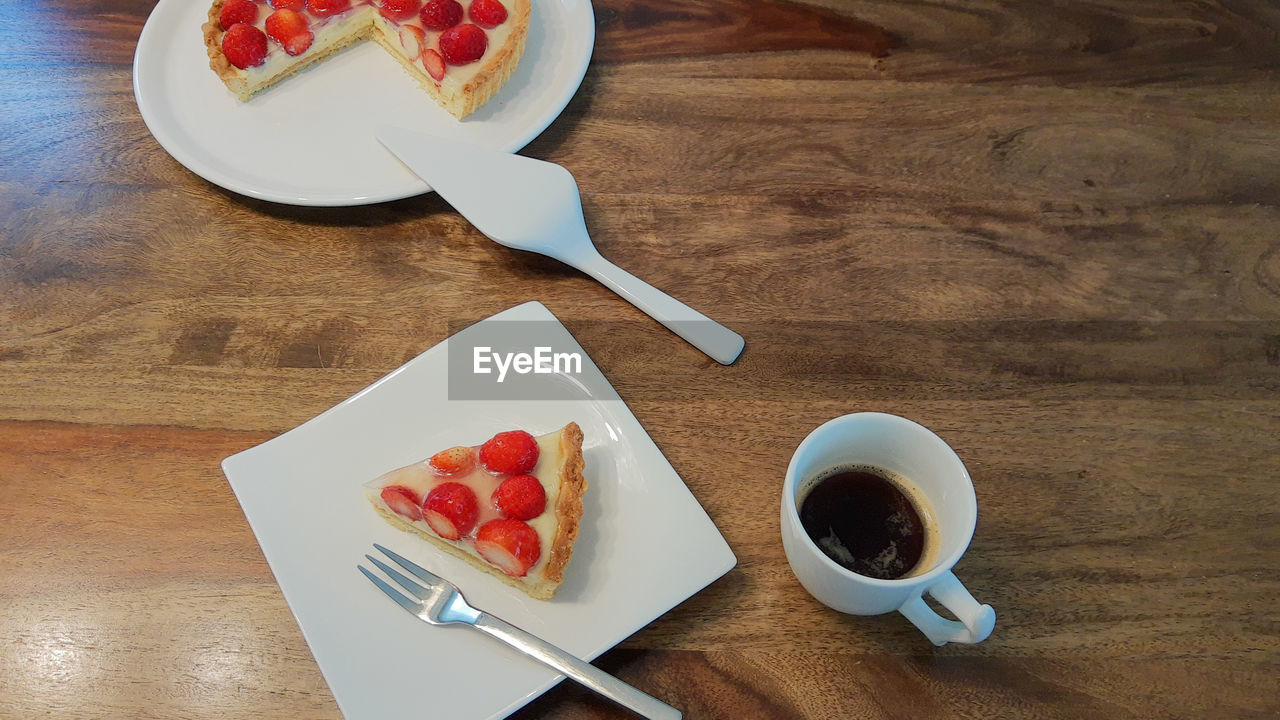 food and drink, food, berry, table, fruit, strawberry, drink, cup, mug, freshness, wood, sweet food, plate, coffee cup, eating utensil, coffee, tableware, kitchen utensil, high angle view, healthy eating, breakfast, sweet, meal, refreshment, dessert, crockery, indoors, baked, spoon, no people, raspberry, fork, cake, produce, preserves, still life, tart, hot drink, wellbeing, directly above, red, dairy, tea, saucer