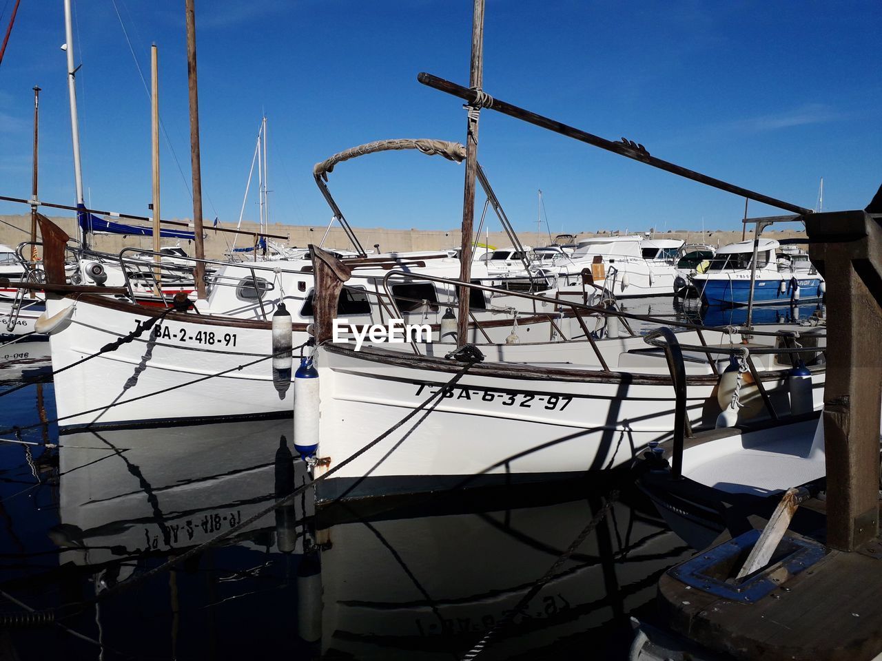 BOATS MOORED IN HARBOR