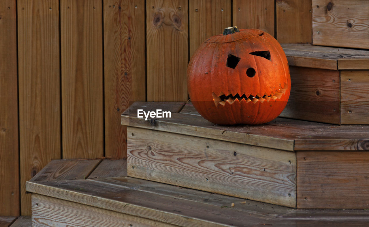 Halloween pumpkin on stairs to house