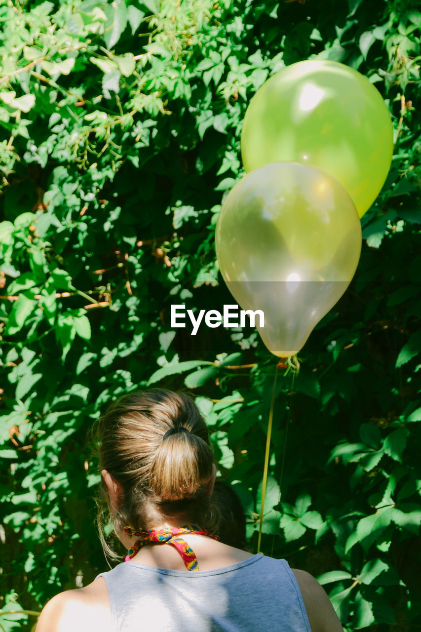 Rear view of woman with balloons