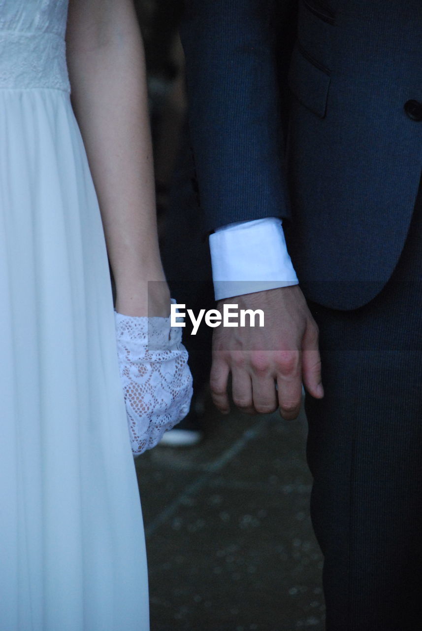 Midsection of newlywed couple 