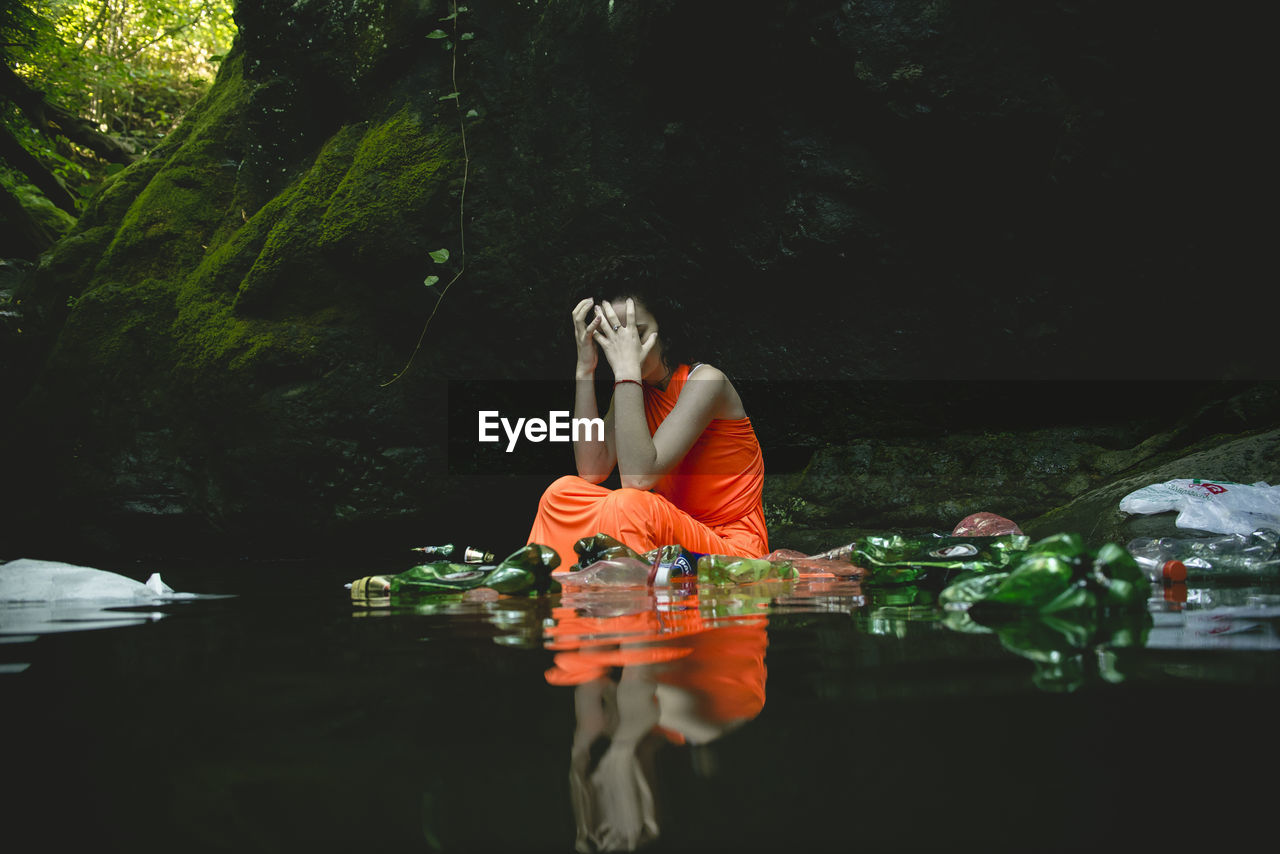 Young woman sitting in lake