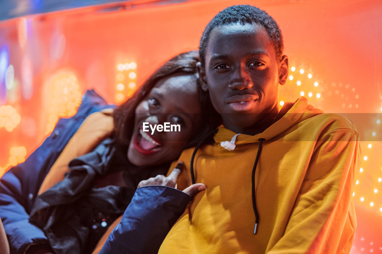 Black couple resting on fairground