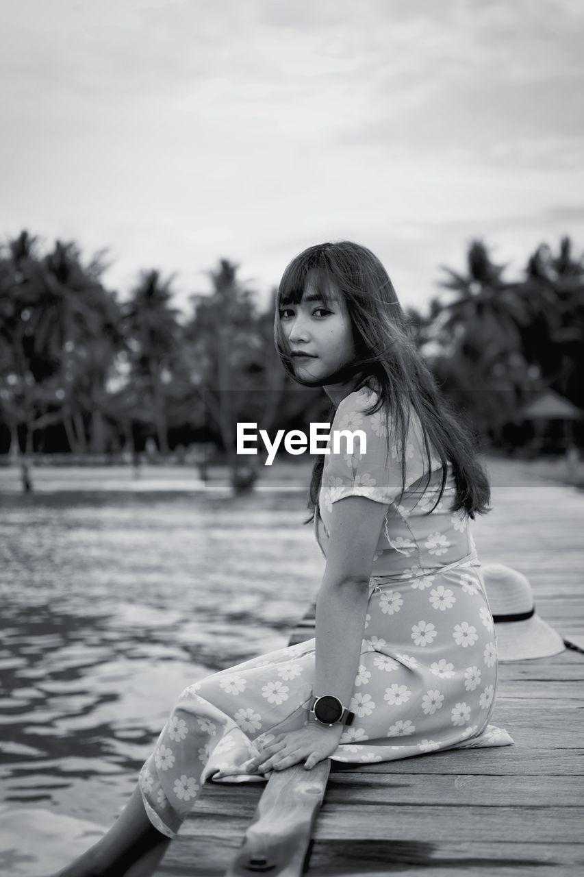 Portrait of young woman sitting on boat