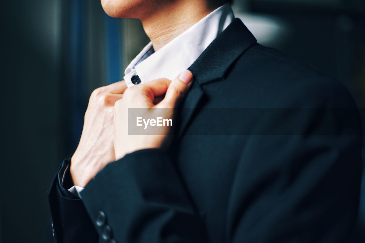 Midsection of businessman wearing suit