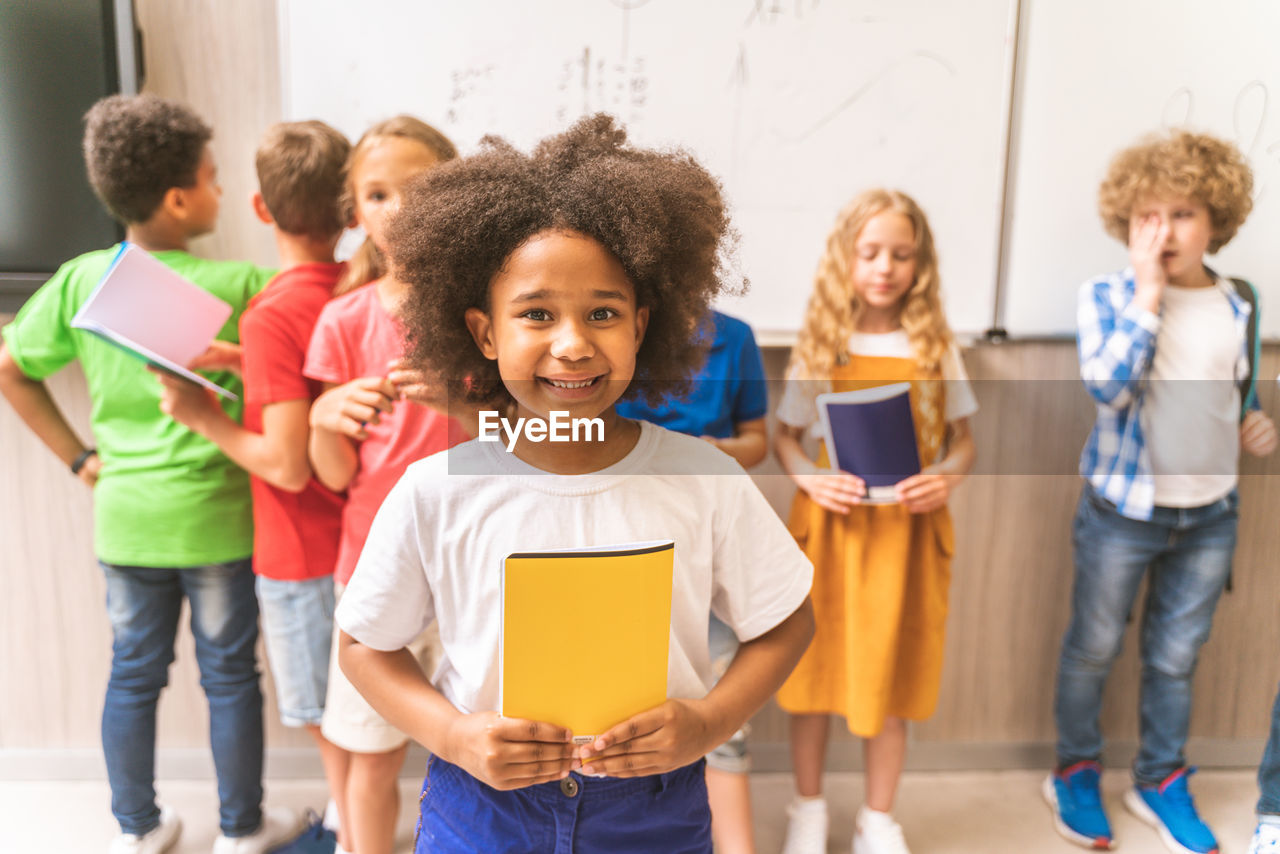 Portrait of smiling girl holding book