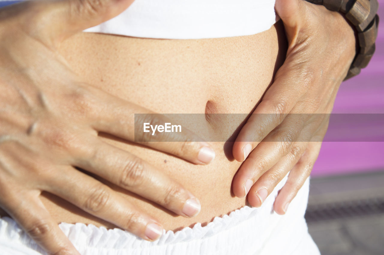 Flat stomach of woman health symptom on hands