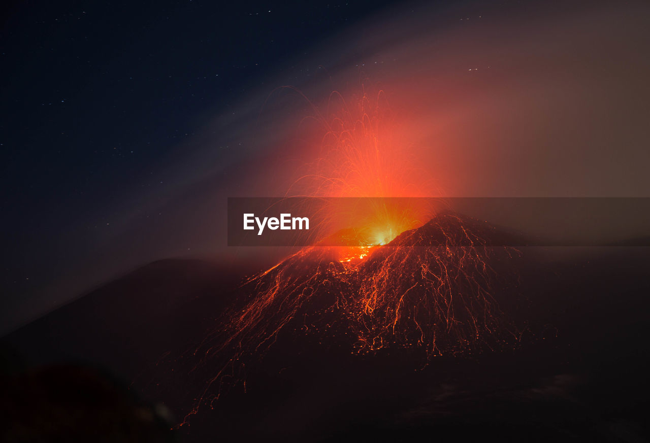 Etna volcano eruption with lava explosion in the night - sicily 