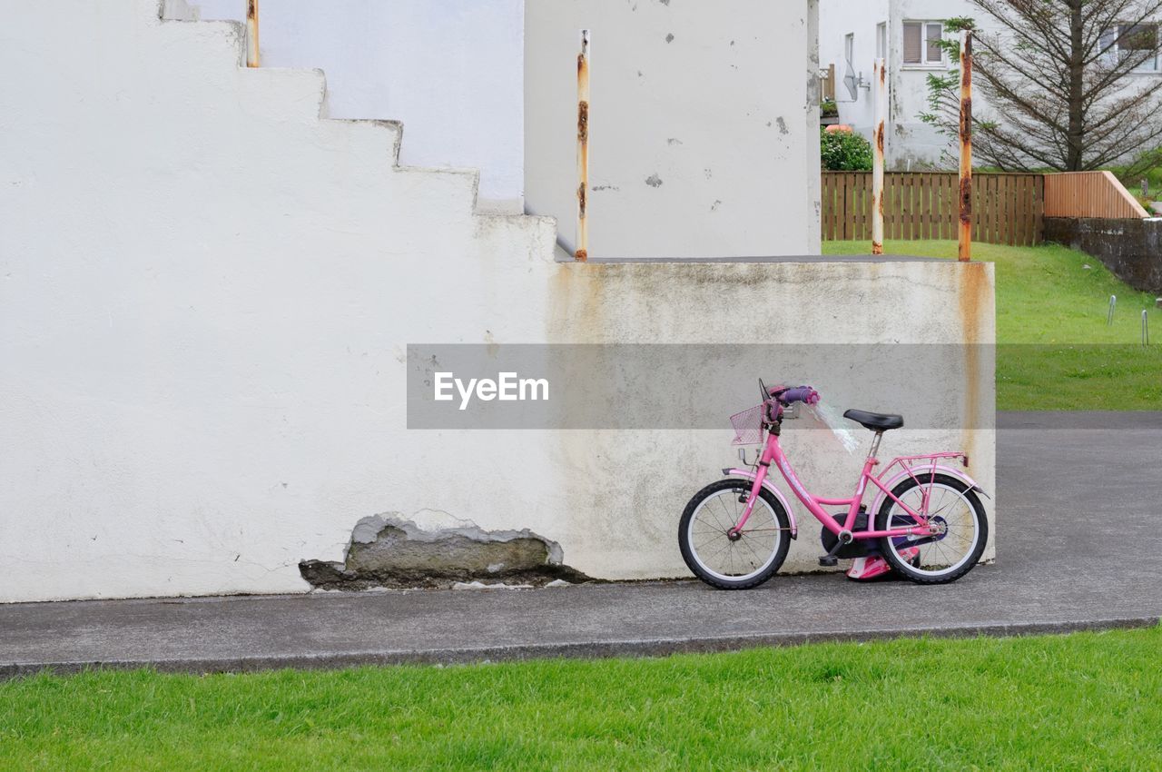 Bicycle against wall in building