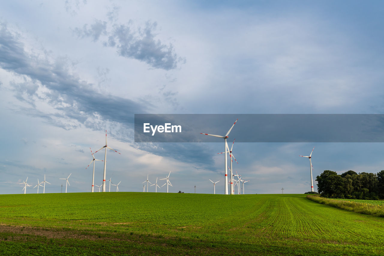 Windmill on field against sky