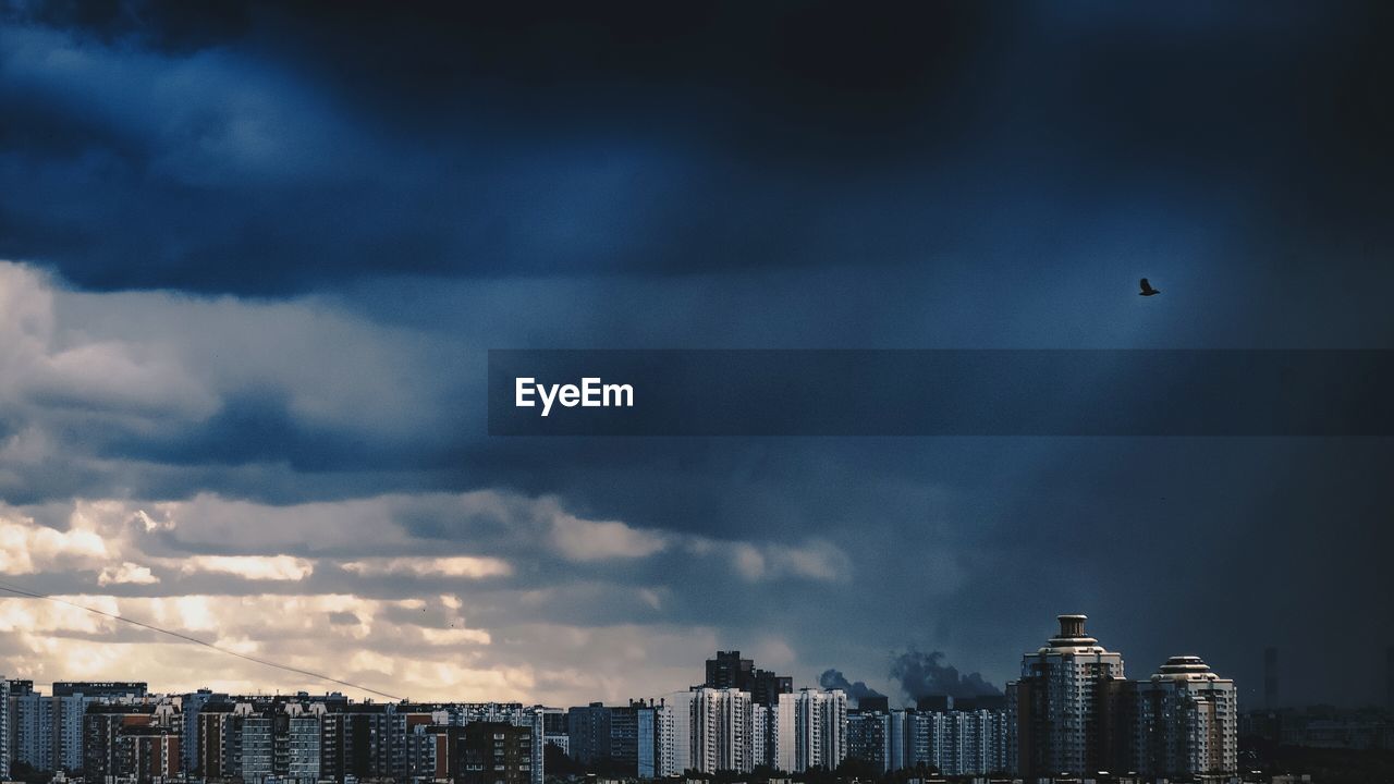 Cityscape against storm clouds