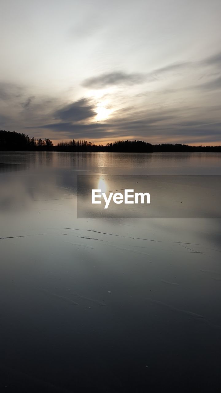 Scenic view of lake against sky during sunset