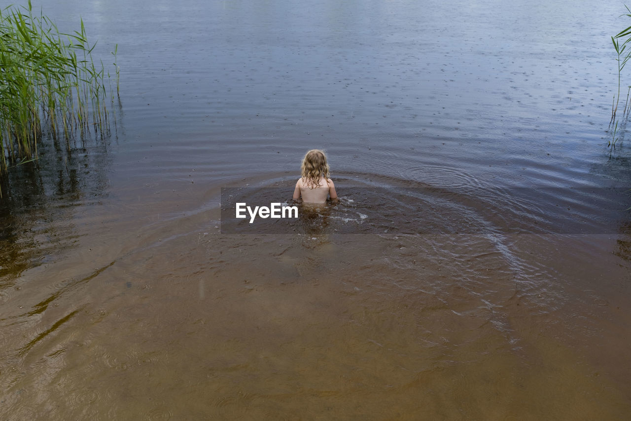 High angle view of girl swimming in lake