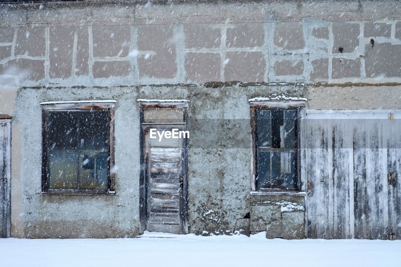 architecture, built structure, building exterior, winter, wall, snow, no people, building, window, day, old, wall - building feature, cold temperature, house, door, white, entrance, abandoned, outdoors, weathered, urban area, nature, facade, residential district, history, wood, closed, home