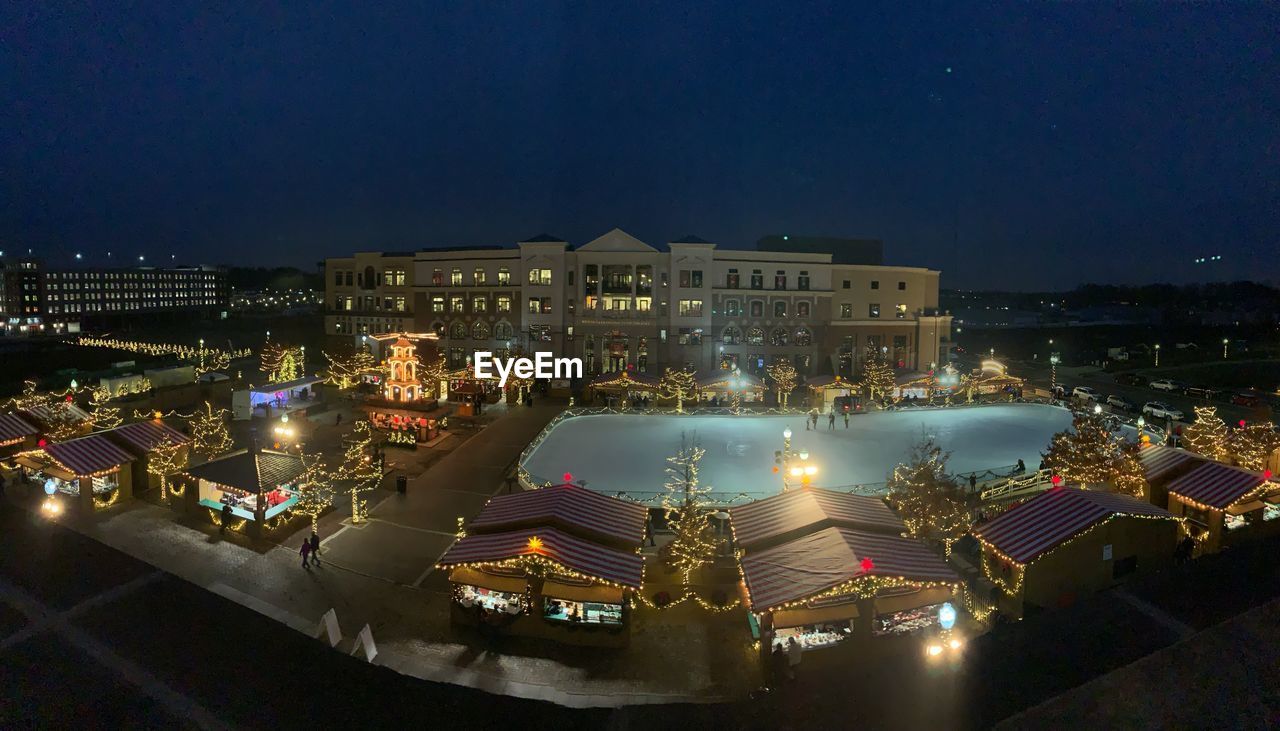 HIGH ANGLE VIEW OF ILLUMINATED BUILDINGS IN CITY