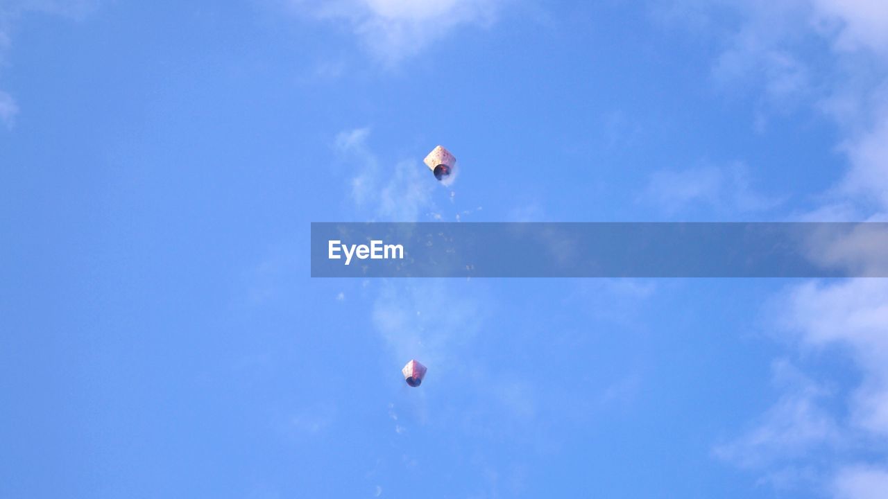 LOW ANGLE VIEW OF FLYING KITE AGAINST BLUE SKY