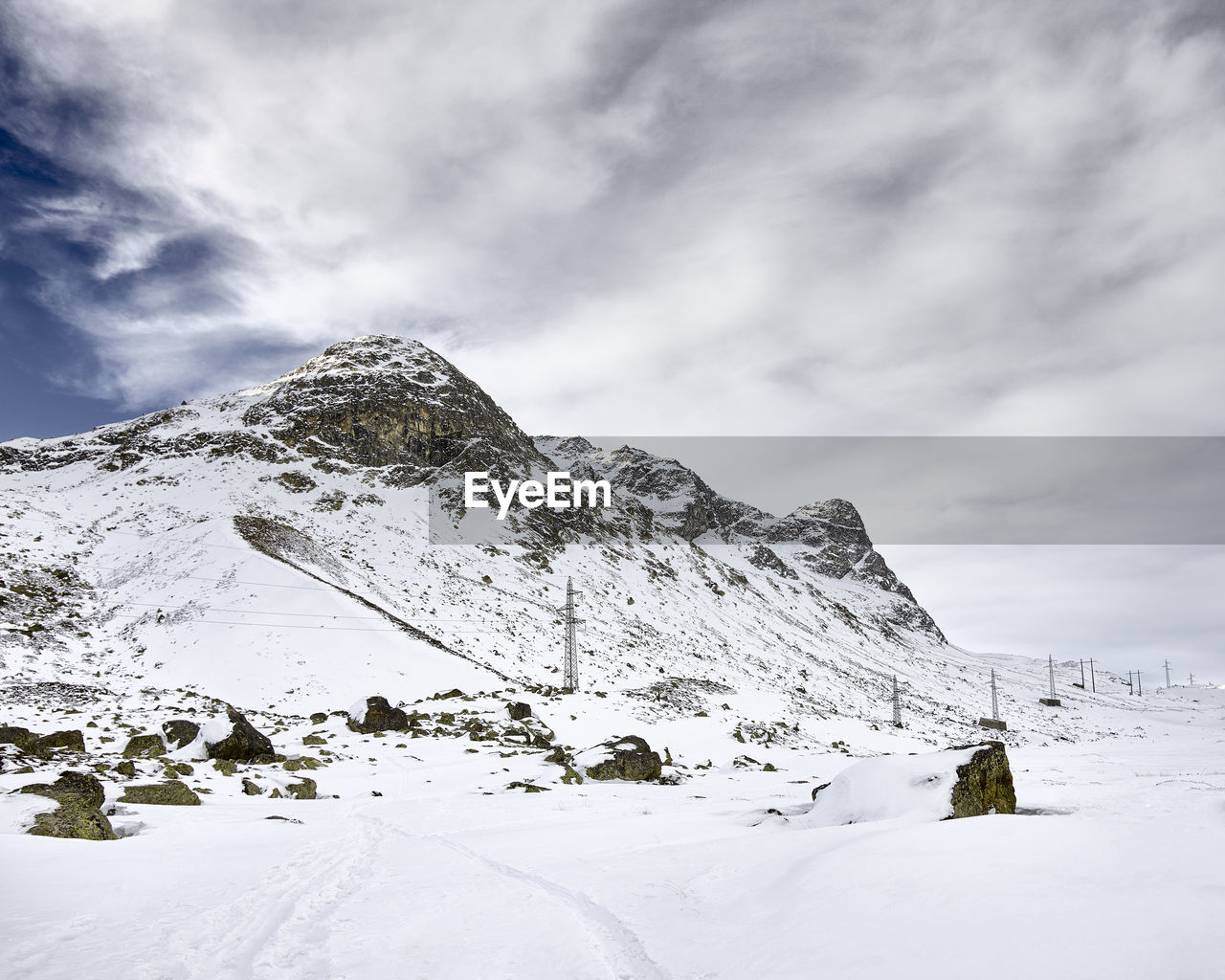 SNOW COVERED MOUNTAINS AGAINST SKY