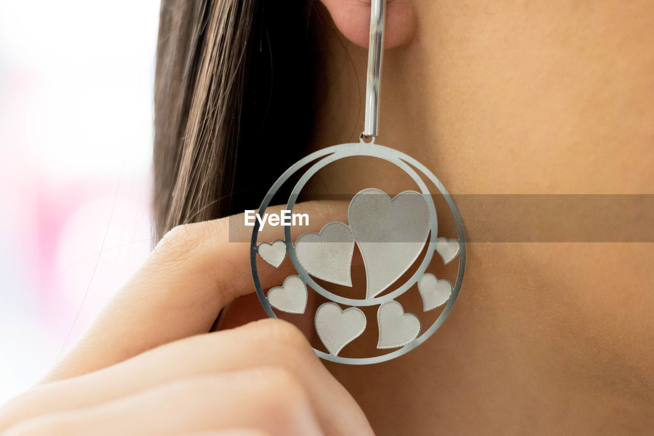 Midsection of woman wearing earring