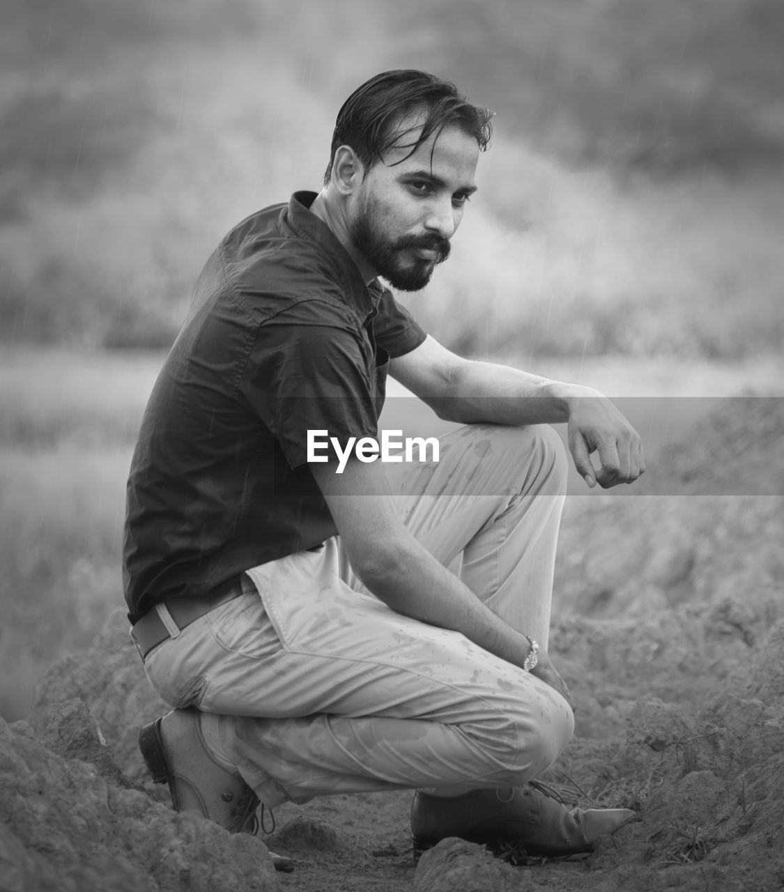 Young man sitting on field