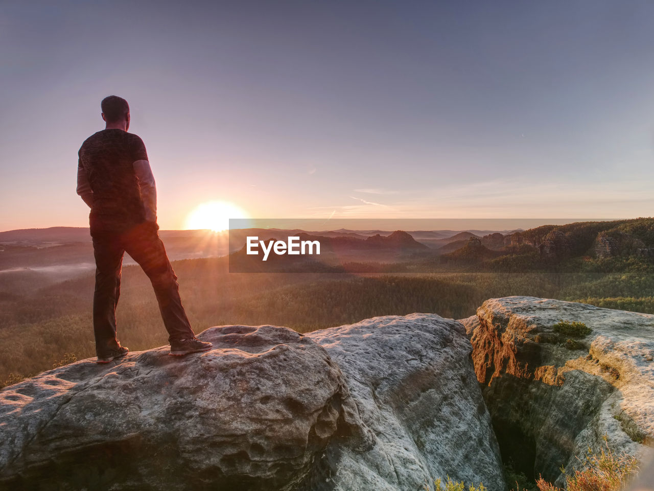 Tall man in sports clothes enjoy morning view into pure nature landscape. guy clear soul