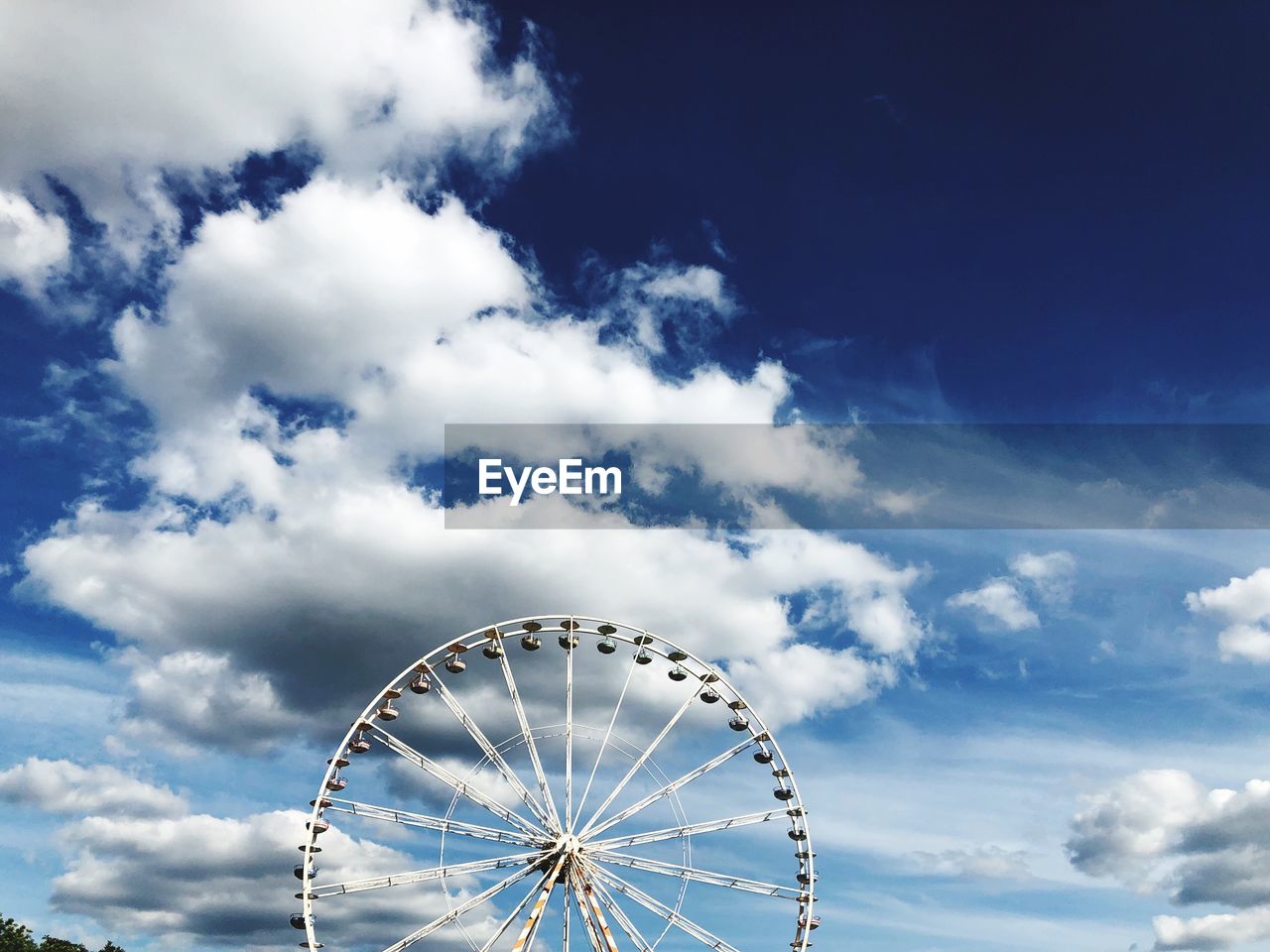 Low angle view of ferris wheel against sky