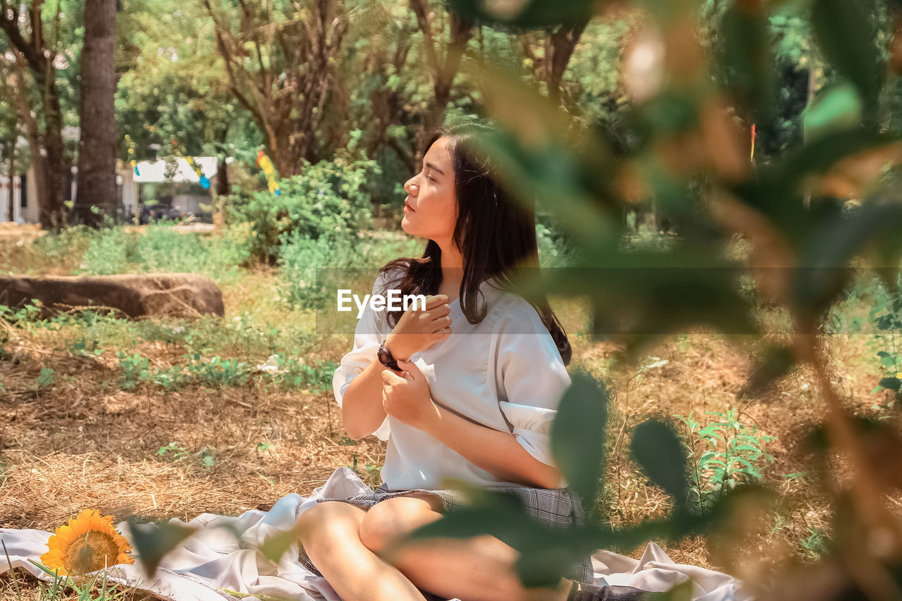 Young woman sitting outdoors