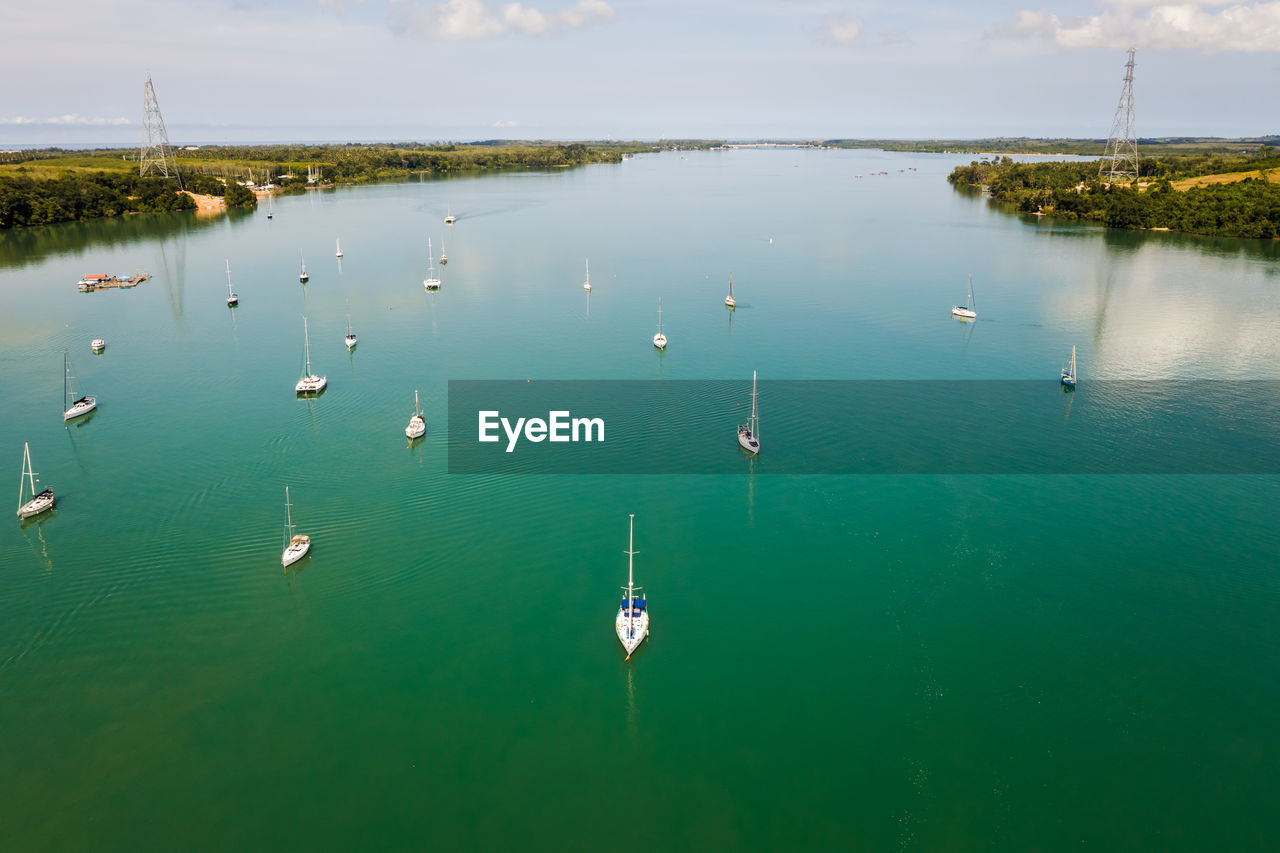 Yacht sailing on green sea aerial view