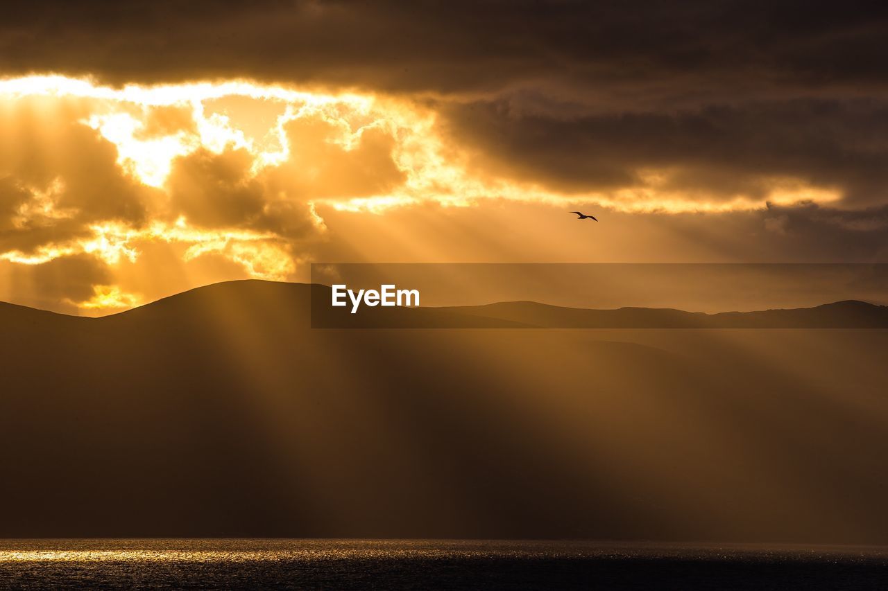 Scenic view of mountains against sky during sunset
