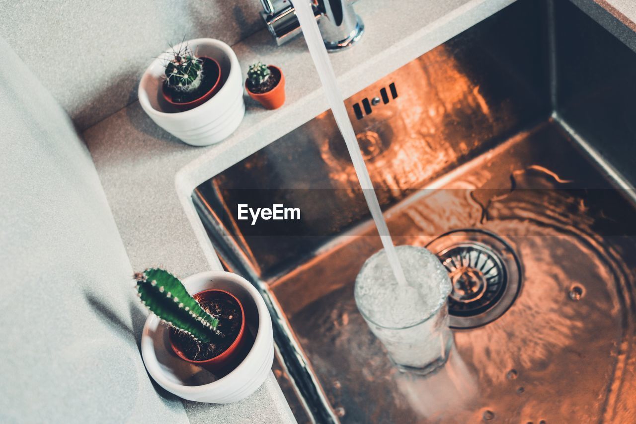 High angle view of water in glass at sink