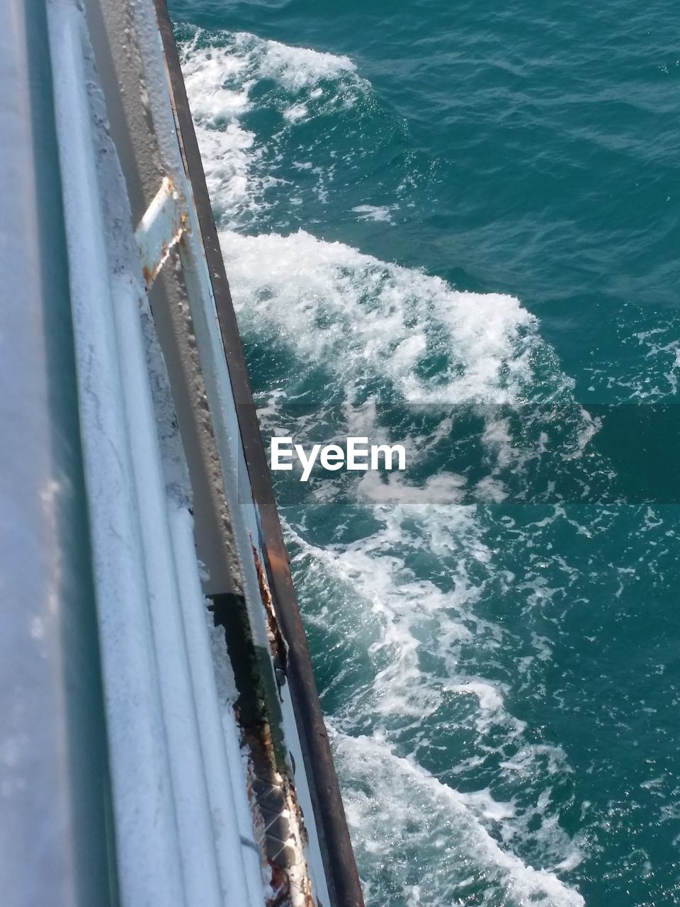 HIGH ANGLE VIEW OF SEA BY MOUNTAIN