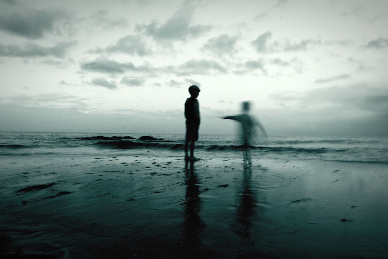 SILHOUETTE MAN WALKING ON BEACH