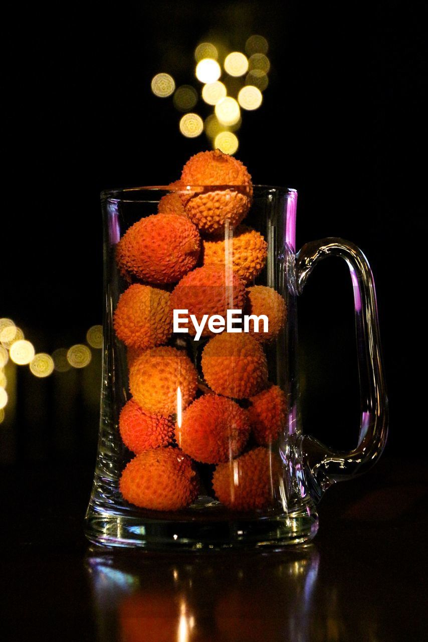 Lychees in glass mug on table