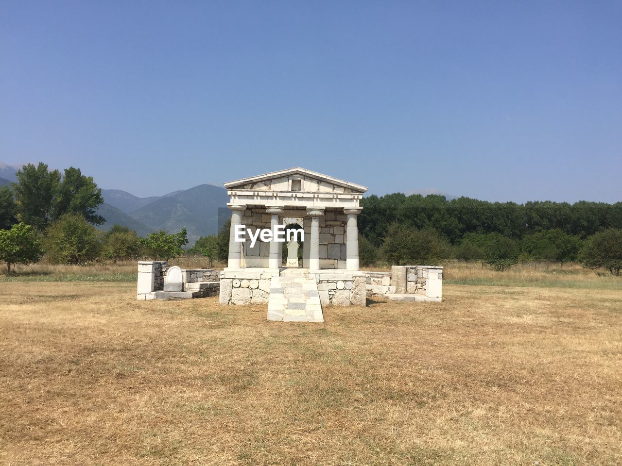 Historic built structure on field against clear sky