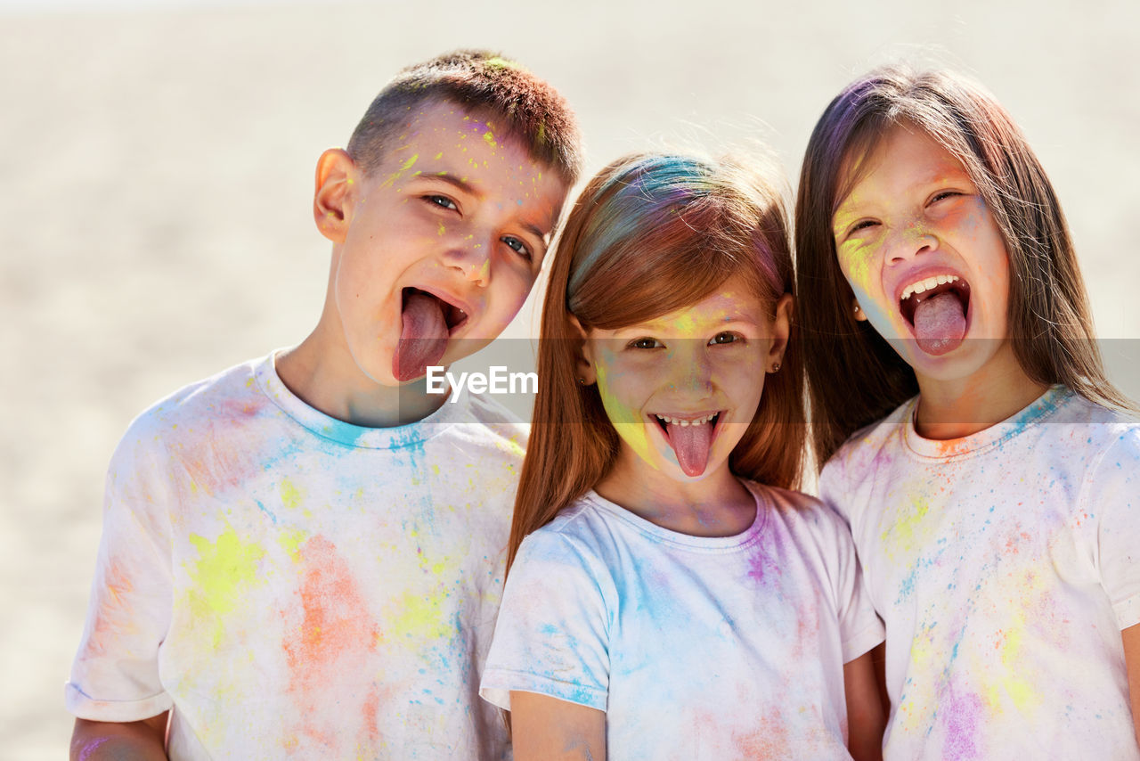 Portrait of smiling kids filthy with powder paint