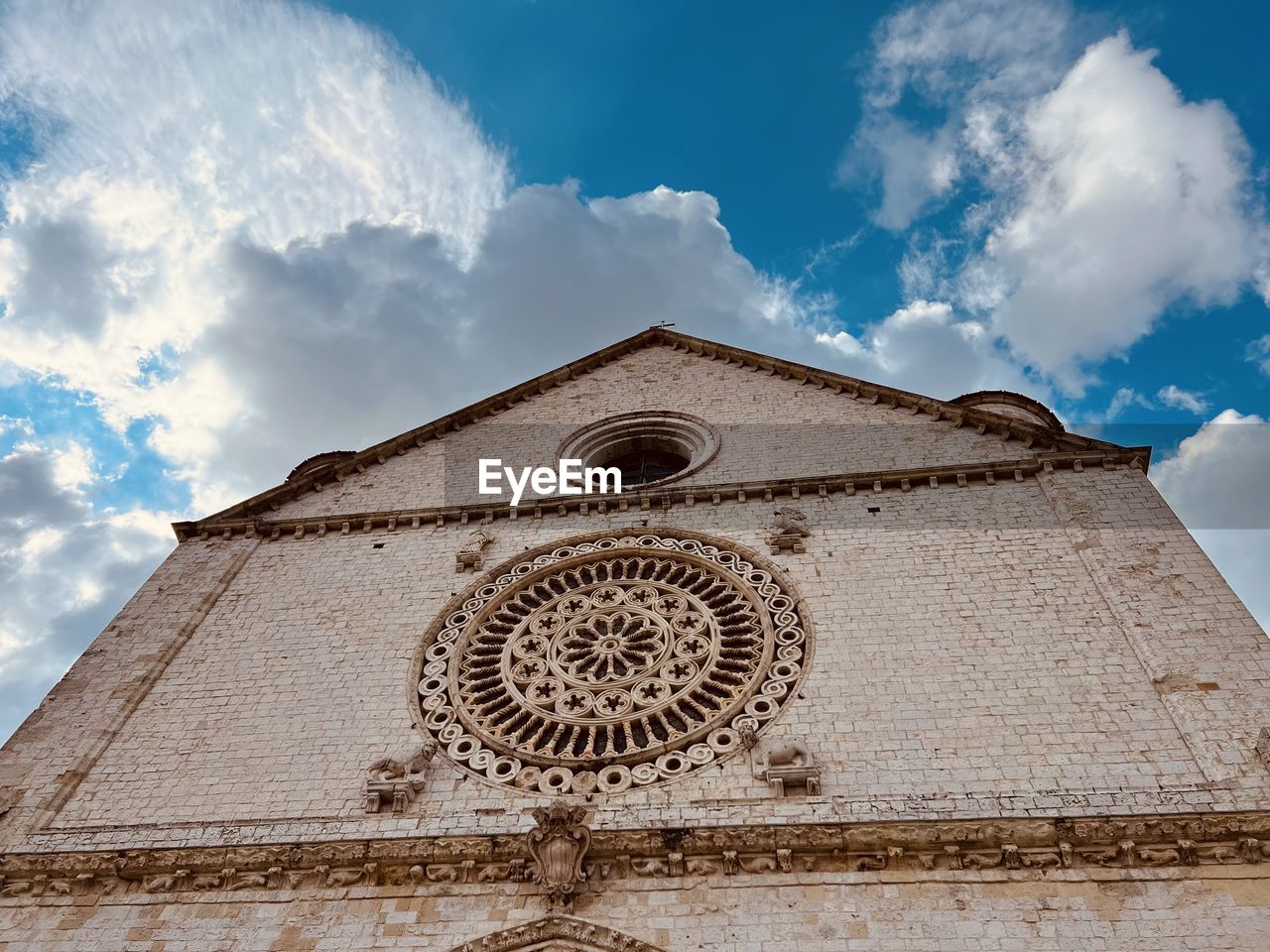 low angle view of building against cloudy sky