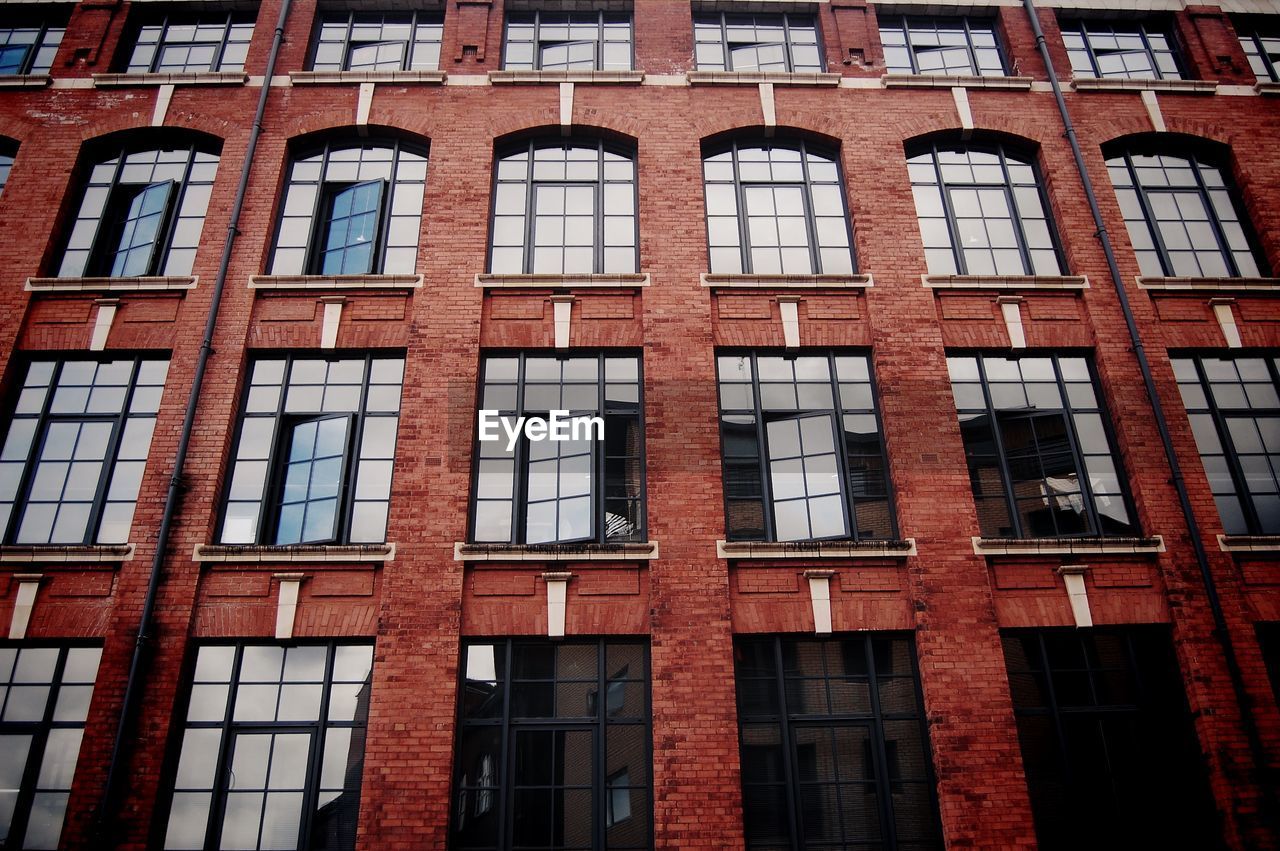 Full frame shot of building with reflection on window glass