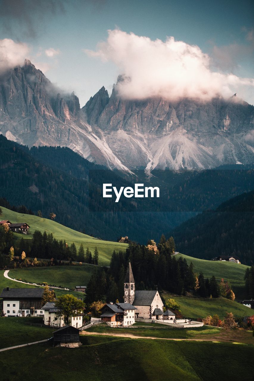 Houses on landscape against mountains